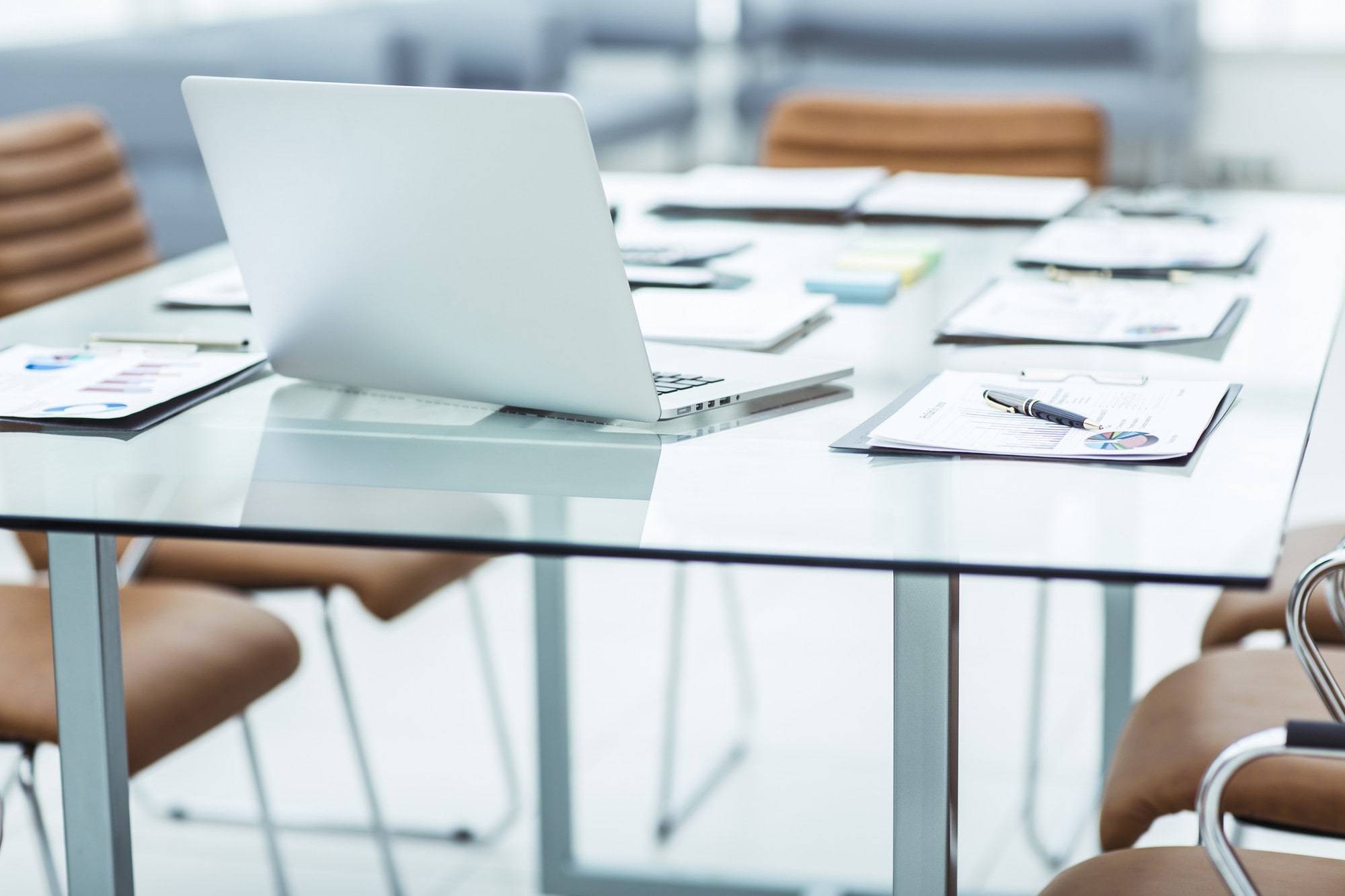 Table with Documents and a Laptop